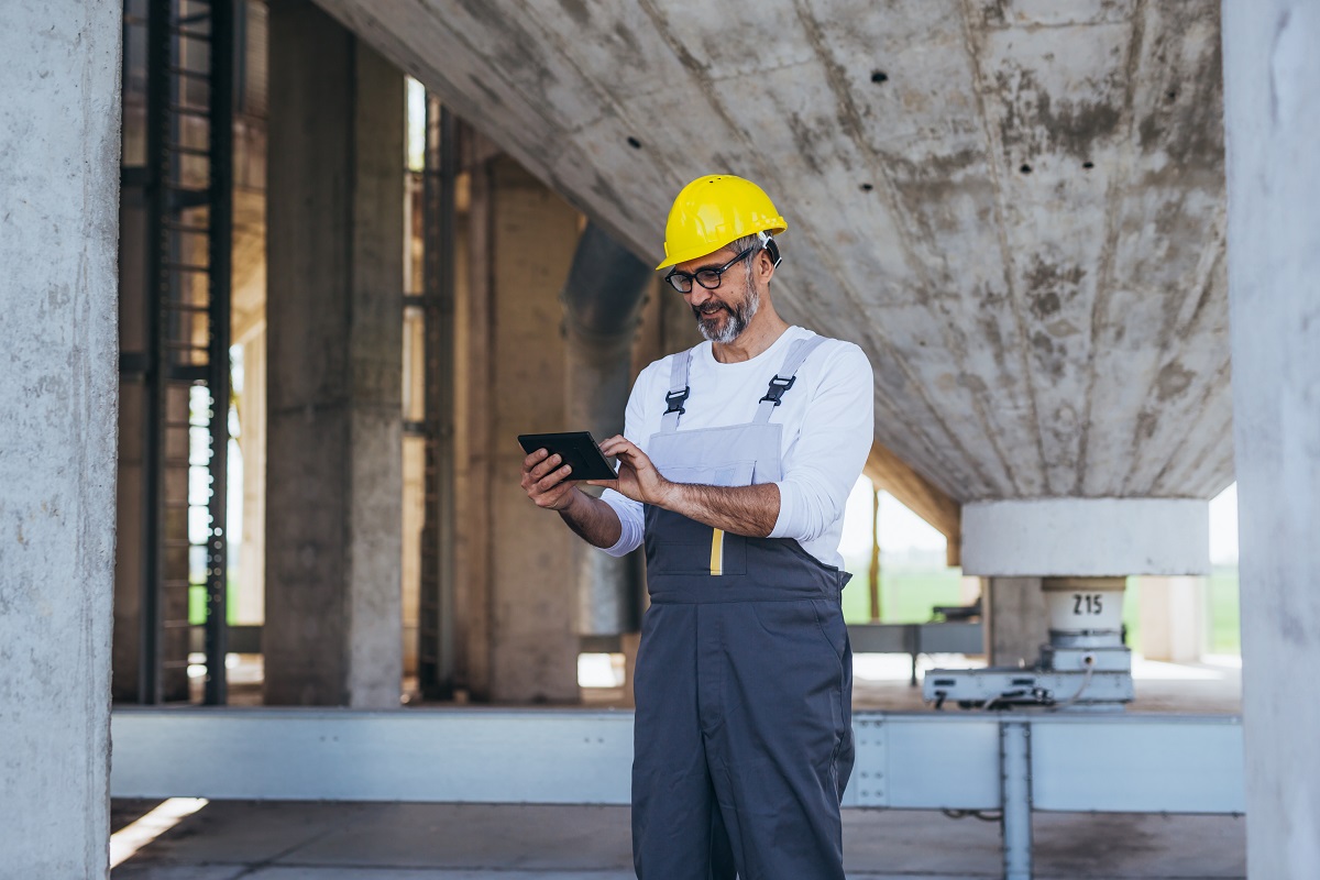 construction worker using tablet on site